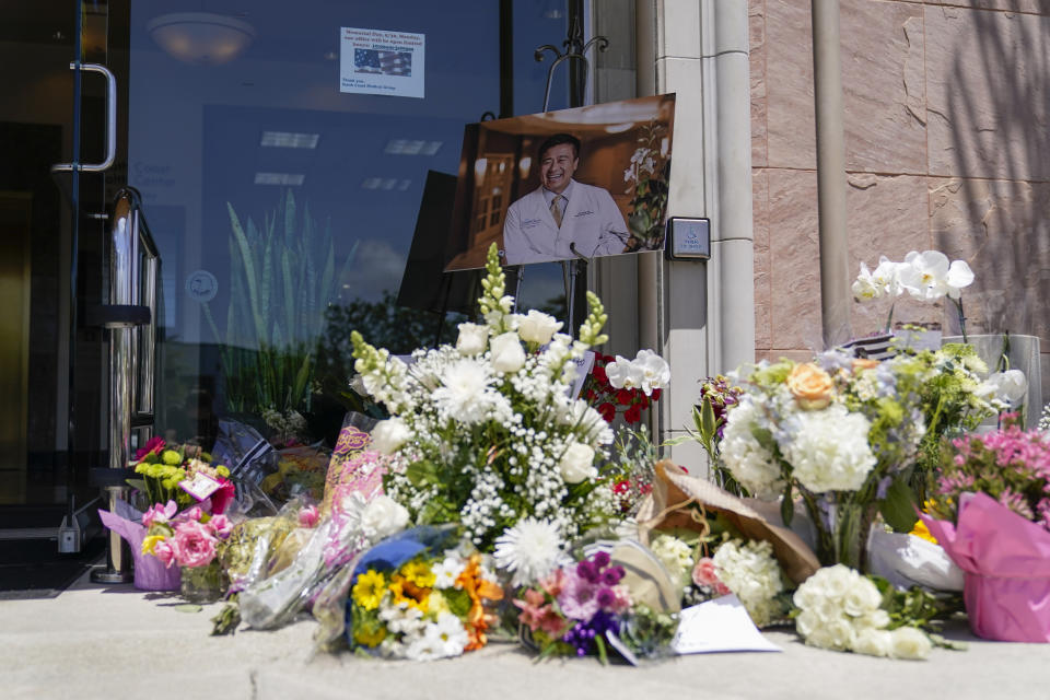 A memorial honoring Dr. John Cheng sits outside his office building on Tuesday, May 17, 2022, in Aliso Viejo, Calif. Cheng, 52, was killed in Sunday's shooting at Geneva Presbyterian Church. (AP Photo/Ashley Landis)