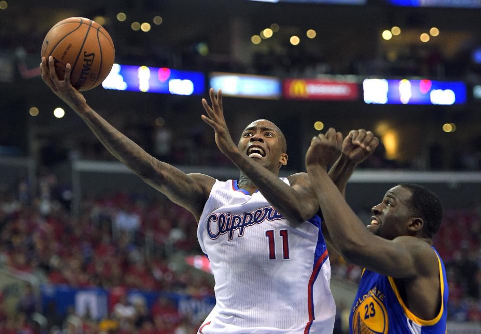 Los Angeles Clippers guard Jamal Crawford, left, goes up for a shot as Golden State Warriors forward Draymond Green defends during the first half in Game 7 of an opening-round NBA basketball playoff series, Saturday, May 3, 2014, in Los Angeles. (AP Photo/Mark J. Terrill)