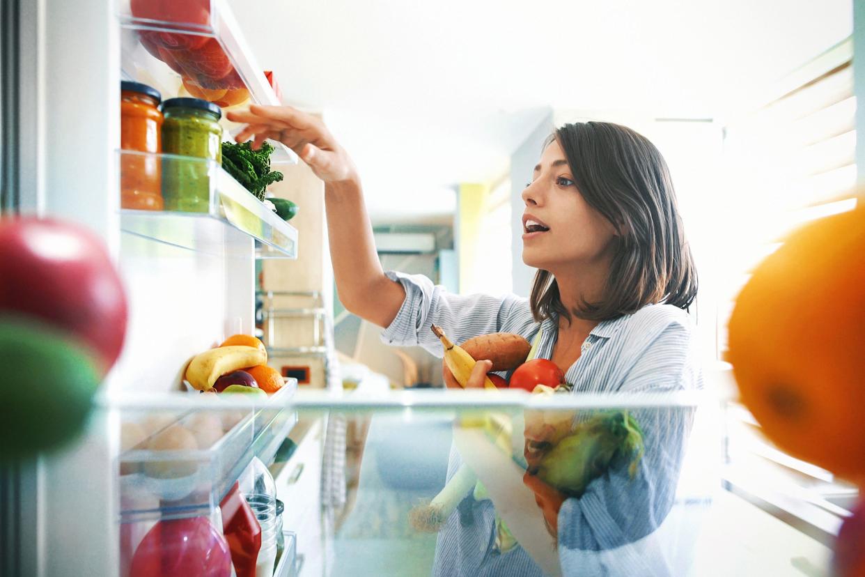 picking some fruit and veggies from the fridge