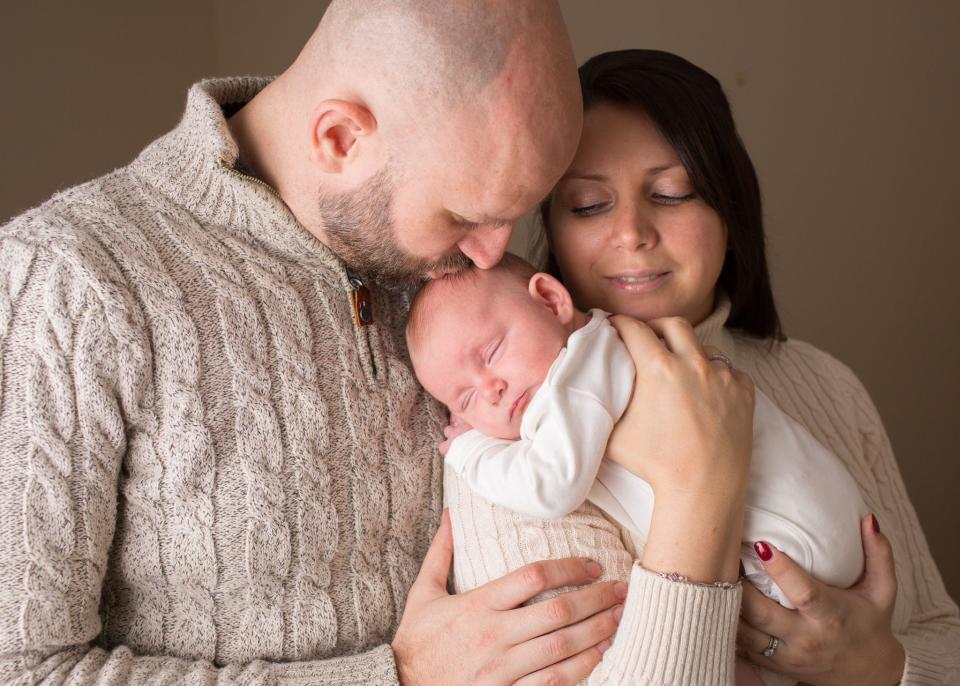 Jodie Fraser with her husband and their daughter, Lily as a newborn. (Supplied)