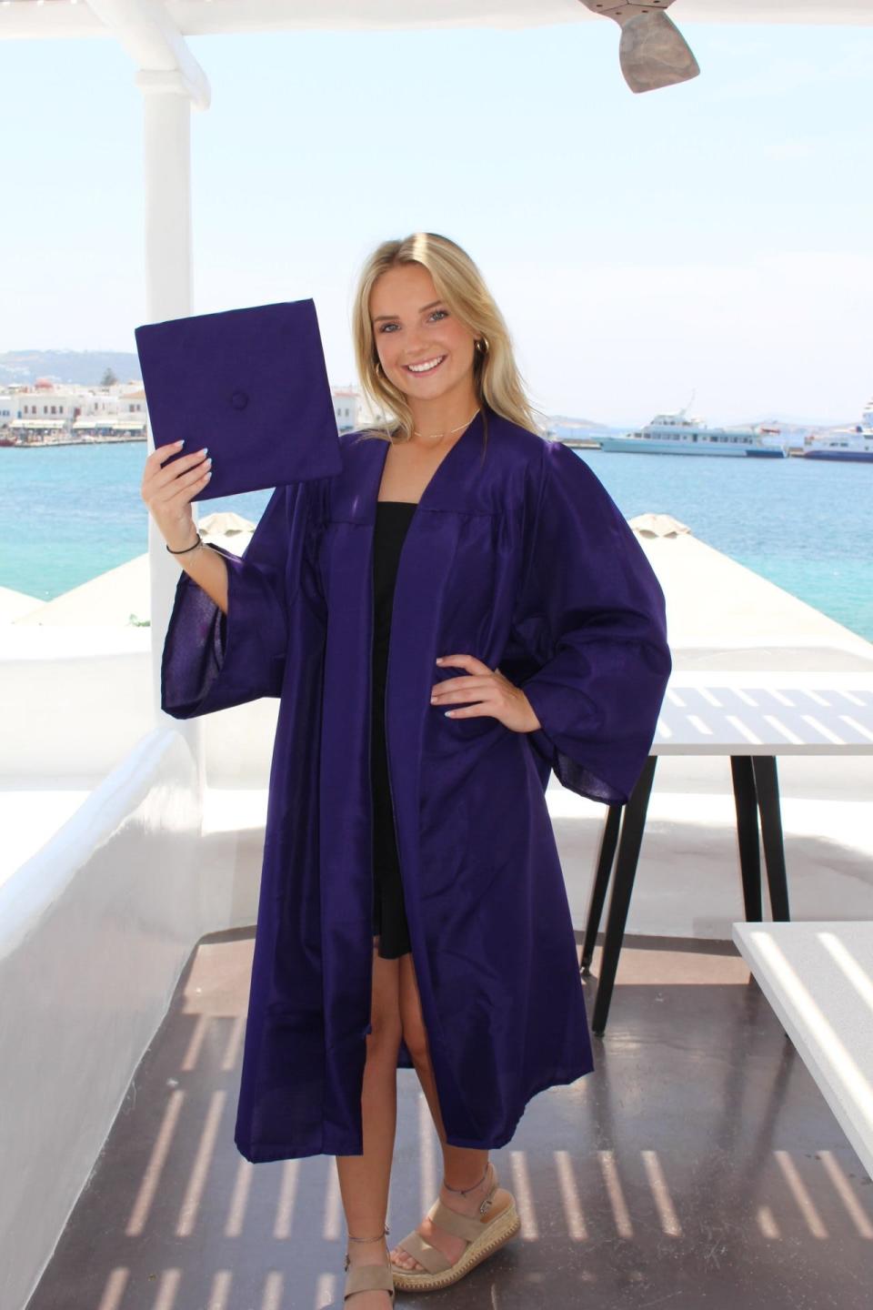 Ava Abel of Winter Garden, Florida, poses with a borrowed graduation gown for her 2024 senior class photo, taken during a family trip this past summer to Greece. Abel and other seniors are pulling out the stops when it comes to their post-COVID senior moments.