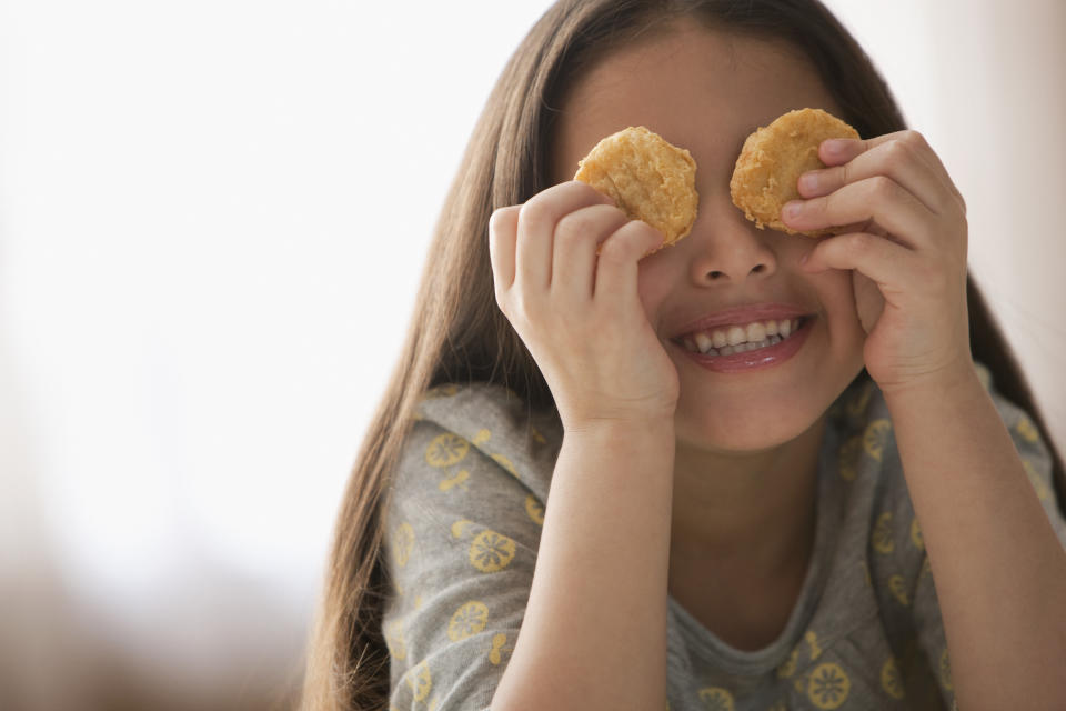 child with chicken nuggets