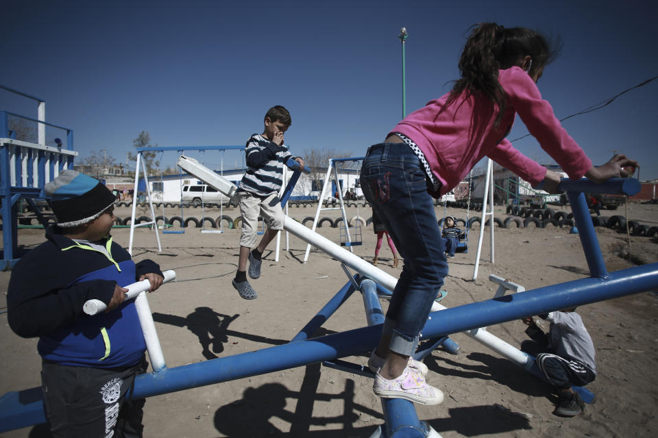 Honduran children migrant play at the Pan de Vida shelter in Ciudad Juarez, Mexico, Friday, Feb. 19, 2021. After waiting months and sometimes years in Mexico, people seeking asylum in the United States are being allowed into the country starting Friday as they wait for courts to decide on their cases, unwinding one of the Trump administration's signature immigration policies that President Joe Biden vowed to end. (AP Photo/Christian Chavez)