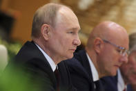 Russian President Vladimir Putin, left, listens to Vietnamese Prime Minister Pham Minh Chinh, not pictured, during a meeting at the government office in Hanoi, Vietnam Thursday, June 20, 2024. (Luoung Thai Linh/Pool Photo via AP)