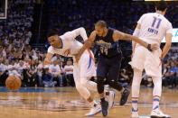 Apr 16, 2016; Oklahoma City, OK, USA; Dallas Mavericks guard Devin Harris (34) fouls Oklahoma City Thunder guard Russell Westbrook (0) during the third quarter in game one of their first round NBA Playoffs series at Chesapeake Energy Arena. Mandatory Credit: Mark D. Smith-USA TODAY Sports