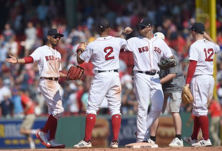 Jul 15, 2018; Boston, MA, USA; Boston Red Sox shortstop Xander Bogaerts (2) celebrates with his teammates after defeating the Toronto Blue Jays at Fenway Park. Mandatory Credit: Bob DeChiara-USA TODAY Sports