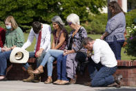 People pray during a vigil at the Collierville Town Hall, Friday, Sept. 24, 2021, in Collierville, Tenn. The vigil is for the person killed and those injured when a gunman attacked people in a Kroger grocery store Thursday before he was found dead of an apparent self-inflicted gunshot wound. (AP Photo/Mark Humphrey)