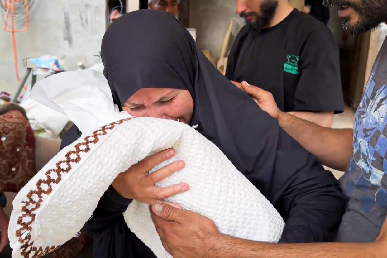 After saying their goodbyes, the family took Sabreen to a dusty, sand-filled cemetery in Rafah, where they dug down with shovels to the grave that her family was buried in a week ago. (NBC News)