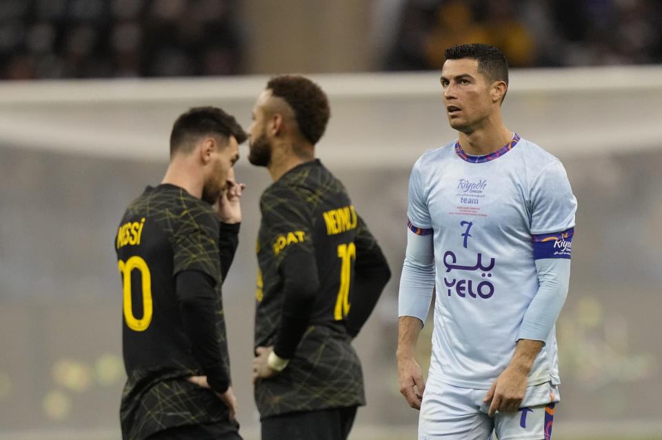 Cristiano Ronaldo playing for a combined XI of Saudi Arabian teams Al Nassr and Al Hilal is flanked by PSG's Lionel Messi and his teammate Neymar during a friendly soccer match, at the King Saud University Stadium, in Riyadh, Saudi Arabia, Thursday, Jan. 19, 2023. (AP Photo/Hussein Malla)