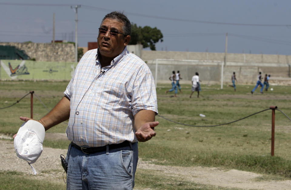 In this May 17, 2012 photo, ex-Haiti soccer star Robert “Boby” Duval speaks on the sidelines of a soccer field, part of his L'Athletique D'Haiti sports program at the northeastern edge of Cite Soleil, in Port-au-Prince, Haiti. Duval is teaming up with a New York real estate developer and a well-known architect to build a soccer stadium in Haiti's notorious Cite Soleil, hoping to revive the seaside shantytown. The organizers also hope the stadium, scheduled to break ground within six months and due to be built by the end of 2013, will bring an initial 500 jobs and inject commerce into the shanty city, where politicians to pay residents to fight their battles as proxy forces. (AP Photo/Dieu Nalio Chery)