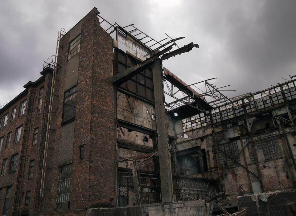 <p>Metal beams protrude from the ruins of a collapsed industrial plant. </p>