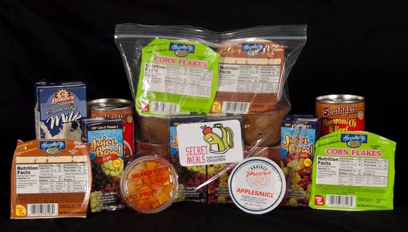 A typical weekend food pack from Secret Meals for Hungry Children contains two milks, two juices, two cereal breakfasts, two lunches consisting of cans of ravioli or macaroni and cheese, and two fruit snacks or fruit cups. [Photo provided by the Alabama Credit Union]