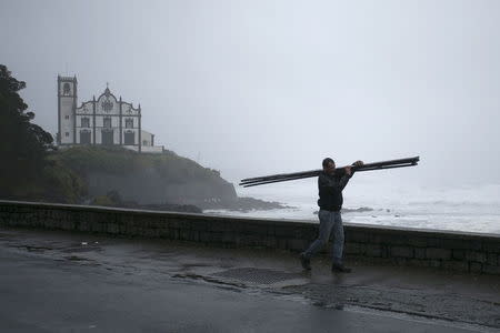 A man walks on the street during the passage of hurricane Alex in Ponta Delgada, Azores, Portugal, January 15, 2016. REUTERS/Rui Soares