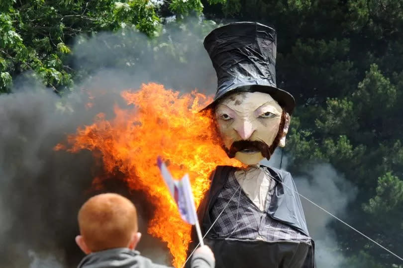 The 'burning of the cork' at Sma' Shot Day