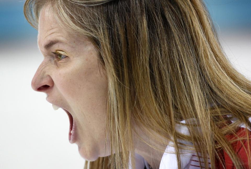 Canada’s skip Jennifer Jones, wearing gold eye shadow, screams for her teammates to sweep harder during the women's curling semifinal game against Britain at the 2014 Winter Olympics, Wednesday, Feb. 19, 2014, in Sochi, Russia. (AP Photo/Robert F. Bukaty)