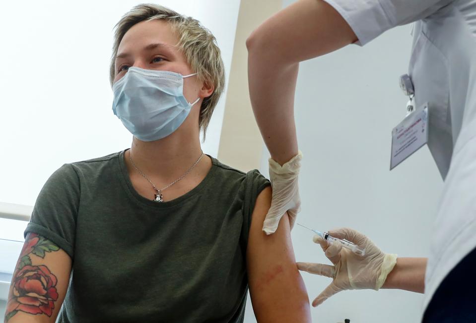 <p>Russian medical worker, right, administers a shot of Russia's Sputnik V coronavirus vaccine in Moscow</p> (AP)