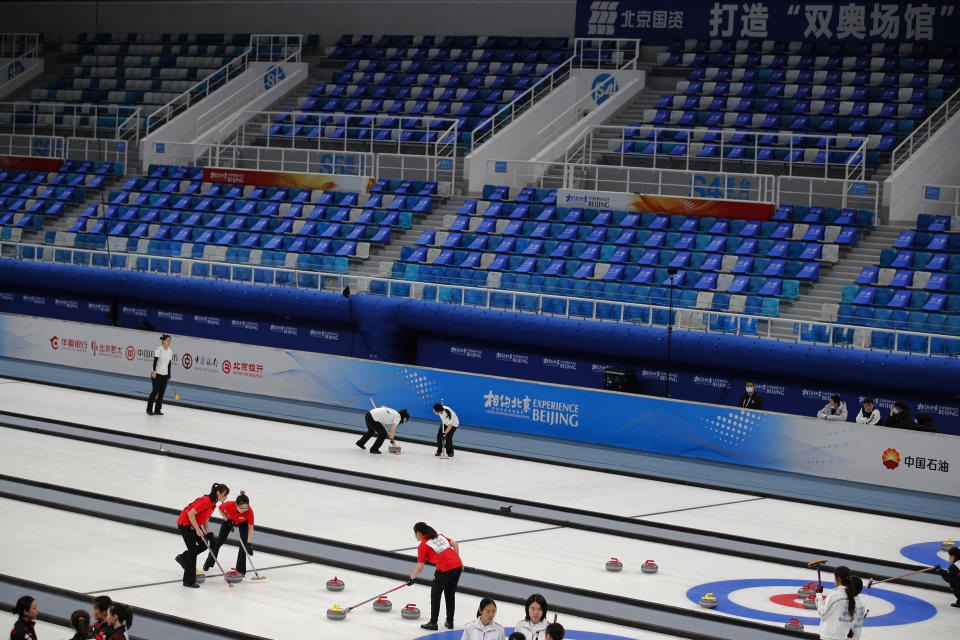 Local teams compete in a curling competition during a test event for the 2022 Beijing Winter Olympics at the National Aquatic Center, also known as the "Water Cube" in Beijing, Saturday, April 3, 2021. The organizers of the 2022 Beijing Winter Olympics has started 10 days of testing for several sport events in five different indoor venues from April 1-10, becoming the first city to hold both the Winter and Summer Olympics. (AP Photo/Andy Wong)