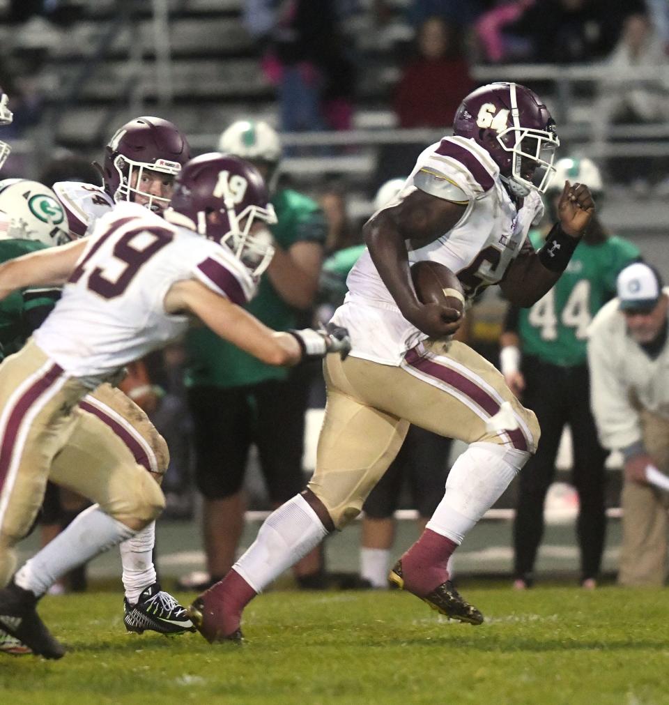 Killingly lineman Terrence Allen scoops up a fumble and starts his touchdown run against Griswold/Wheeler earlier this season. Killingly blanked Woodstock Academy, 35-0, on Thanksgiving Day.