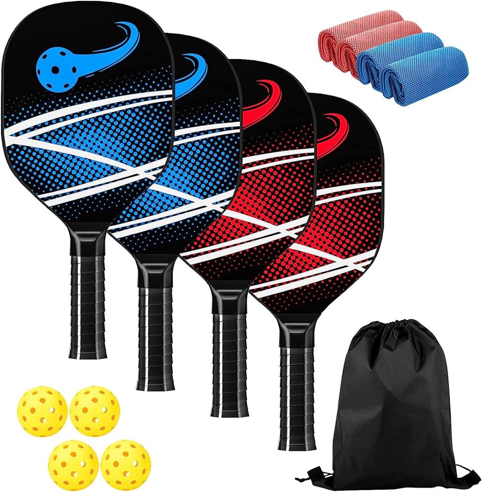 Four pickleball paddles with four plastic balls, four soft cloths and a black carrying bag