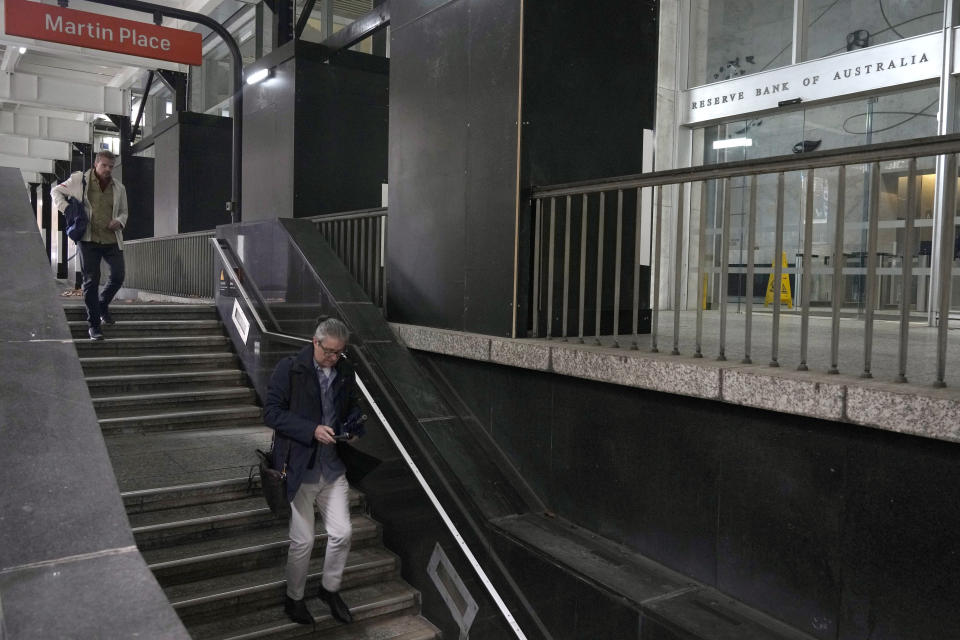 Men walk down stairs to a train station in front of the Reserve Bank of Australia in Sydney, Tuesday, June 6, 2023. Australia’s central bank has lifted its benchmark interest rate for a 12th consecutive time to 4.1% and warned further rises could follow. (AP Photo/Rick Rycroft)