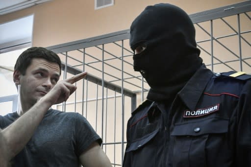 Opposition member Ilya Yashin gestures at a guard during court hearings last year when he was was sentenced for another 10 days in jail after 10 days of detention for unauthorised demonstration