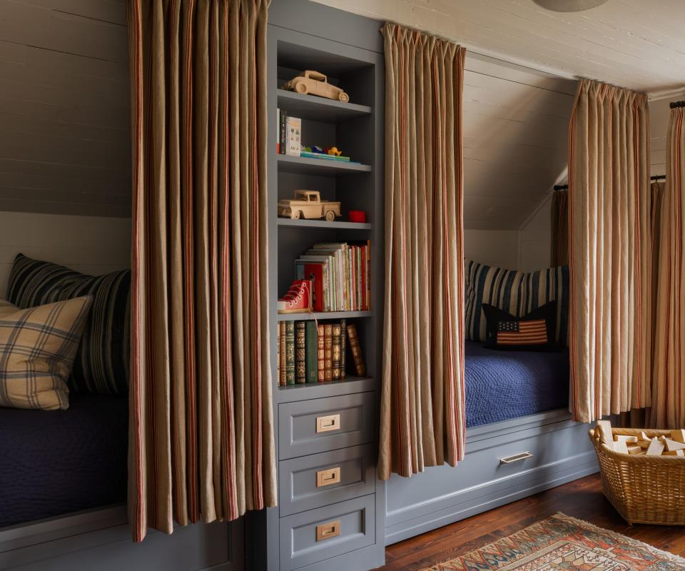 blue painted bunk beds with curtains and book case