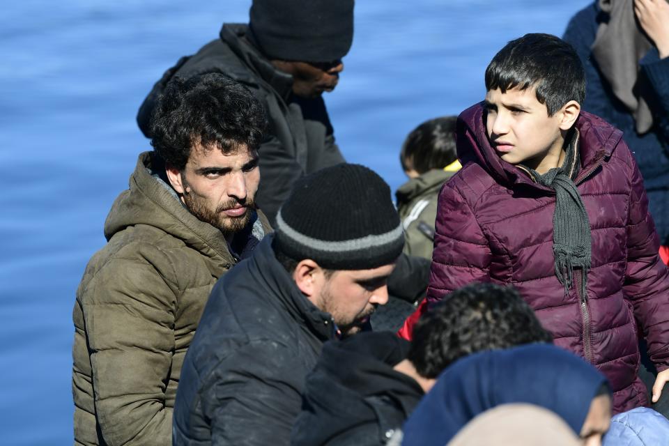 Local residents prevent migrants from reaching the small port of Thermi, on the Greek island of Lesbos, after crossing the Aegean sea on a dinghy from Turkey, Sunday, March 1, 2020. Migrants and refugees were trying to enter Greece by land and by sea Sunday despite Greece making clear it would not allow anyone in, after Turkey officially declared its western borders open to those hoping to head into the European Union. (AP Photo)