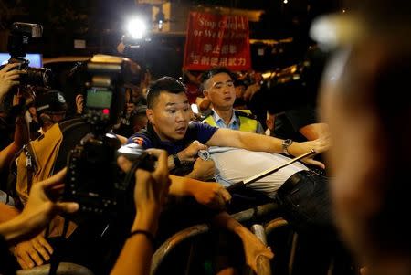 A demonstrator is detained by police during a protest against what they call Beijing's interference over local politics and the rule of law, a day before China's parliament is expected to announce their interpretation of the Basic Law in light of two pro-independence lawmakers' oath-taking controversy, in Hong Kong, China November 6, 2016. REUTERS/Tyrone Siu