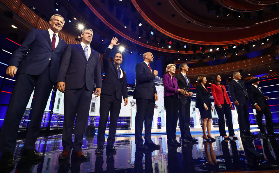 From left, New York City Mayor Bill de Blasio, Rep. Tim Ryan, D-Ohio, former Housing and Urban Development Secretary Julian Castro, Sen. Cory Booker, D-N.J., Sen. Elizabeth Warren, D-Mass., former Texas Rep. Beto O’Rourke, Sen. Amy Klobuchar, D-Minn., Rep. Tulsi Gabbard, D-Hawaii, Washington Gov. Jay Inslee, and former Maryland Rep. John Delaney pose for a photo on stage before the start of a Democratic primary debate hosted by NBC News at the Adrienne Arsht Center for the Performing Arts, Wednesday, June 26, 2019, in Miami. (AP Photo/Brynn Anderson)