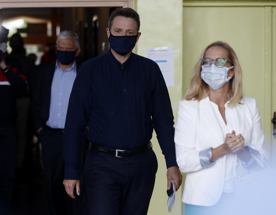 Presidential candidate Rafal Trzaskowski accompanied by his wife Malgorzata arrives to cast his vote during the presidential election runoff in Rybnik, Poland, Sunday, July 12, 2020. Voting started Sunday in Poland's razor-blade-close presidential election runoff between the conservative incumbent Andrzej Duda and liberal, pro-European Union Warsaw Mayor Rafal Trzaskowski. (AP Photo/Petr David Josek)