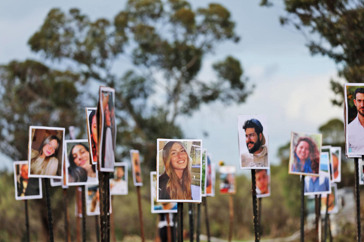 Pictures of victims of the Nova music festival attack are displayed at the site near Kibbutz Re'im and Israel's border with Gaza on Nov. 28, 2023. (Spencer Platt / Getty Images)