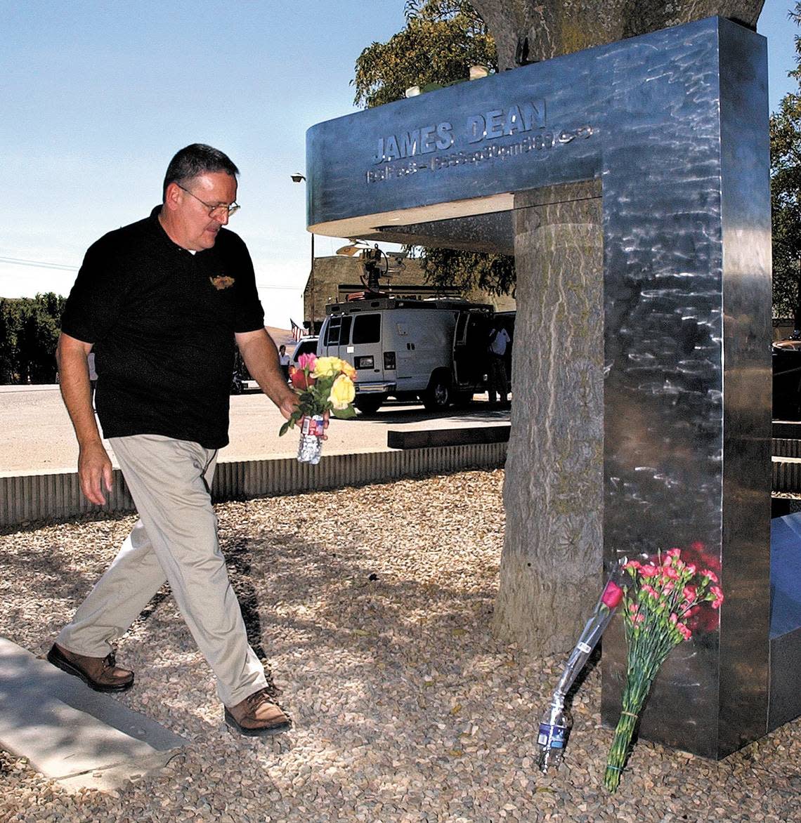 Eugene Pellegrini of Capitola places flowers at the James Dean memorial in Cholame in 2005. Dean died in a car crash near there in 1955.