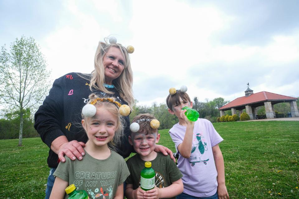 Delina Agent, Ruby Warf. Cooper Warf and Langston Brady celebrate the eclipse with a Sun Drop and snacks at Riverwalk Park in Columbia, Tenn. on April 8, 2024.