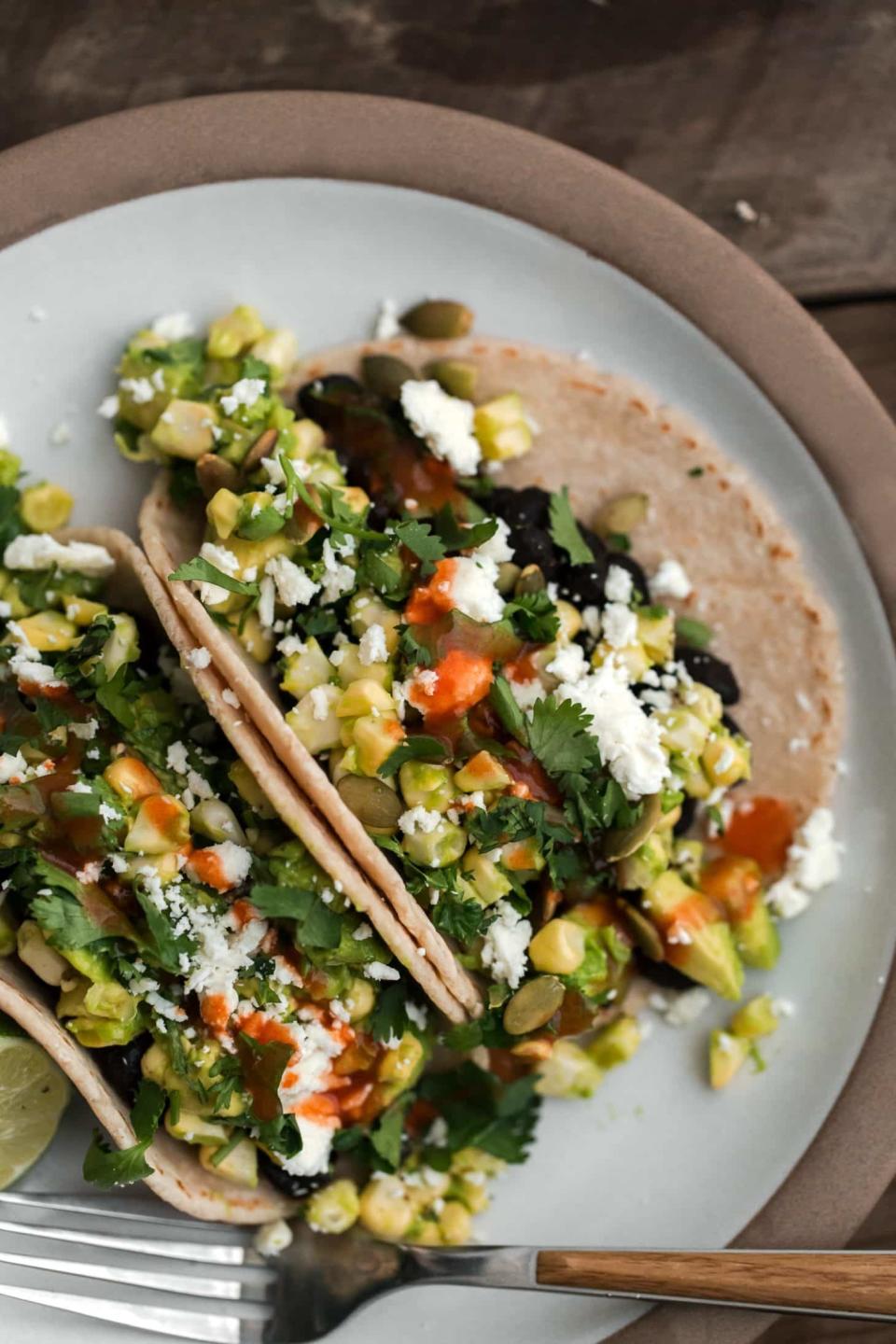 <strong>Get the <a href="https://naturallyella.com/sweet-corn-salad-tacos/" target="_blank">Black Bean Tacos with California Avocado-Sweet Corn Salad recipe</a>&nbsp;from Naturally Ella</strong>