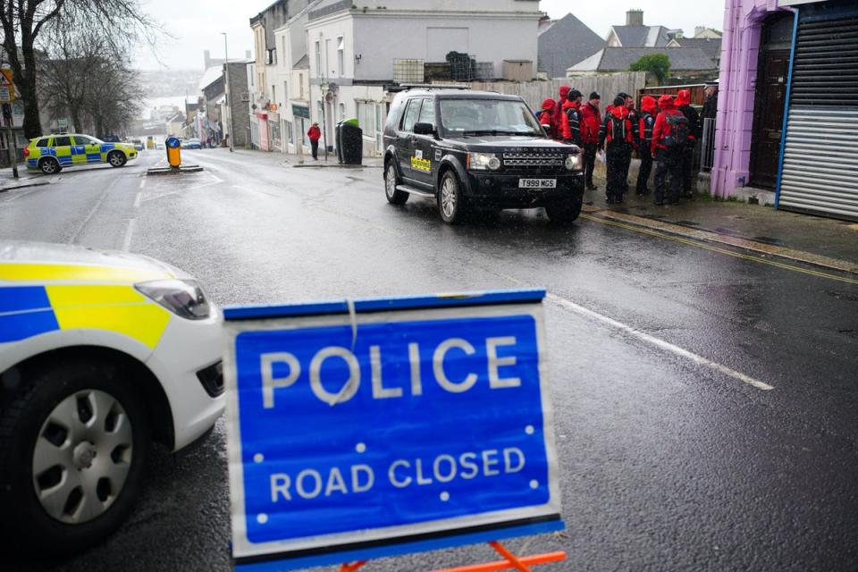 Emergency workers gather near the Torpoint Ferry crossing in Plymouth where a suspected Second World War explosive device discovered in a garden will be taken by military convoy to be disposed of at sea (Ben Birchall/PA) (PA Wire)