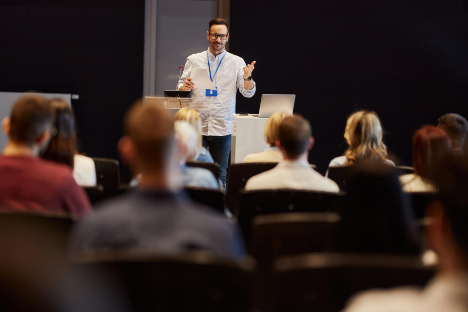 person talking in front of a crowd