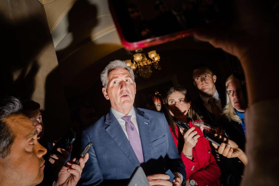 House Speaker Kevin McCarthy surrounded by reporters