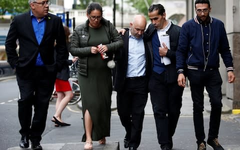  Marcio and Andreia Gomes, parents of Logan Gomes, are comforted as they arrive for a commemoration hearing  - Credit: HENRY NICHOLLS /Reuters