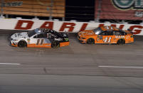 Denny Hamlin (11) races ahead of Daniel Suarez (41) during a NASCAR Cup Series auto race on Sunday, Sept. 1, 2019, at Darlington Raceway in Darlington, S.C. (AP Photo/Richard Shiro)