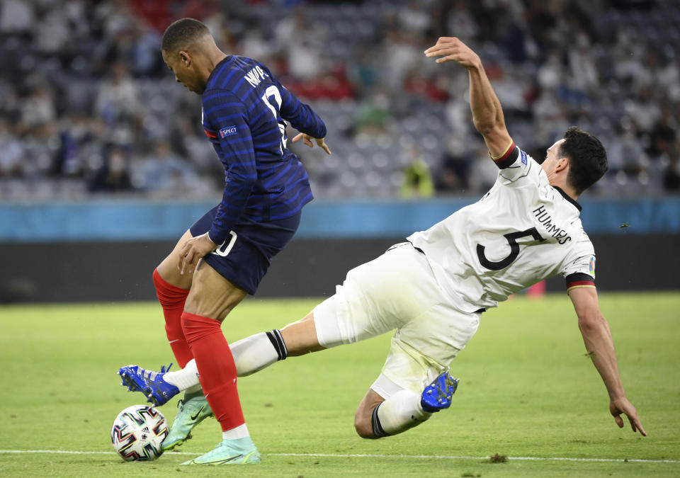 Germany's Mats Hummels, right, challenges France's Kylian Mbappe during the Euro 2020 soccer championship group F match between Germany and France at the Allianz Arena stadium in Munich, Tuesday, June 15, 2021. (Franck Fife/Pool via AP)