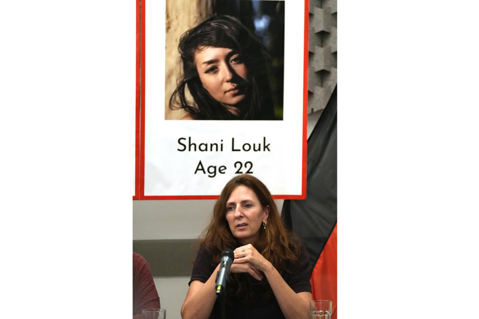 FILE - Ricarda Louk sits in front of a placard of her missing daughter Shani Louk Tuesday Oct. 17, 2023, in Tel Aviv. The Israeli military said Friday, May 17, 2024, it found the bodies of three Israeli hostages in Gaza, including Louk. (AP Photo/Maya Alleruzzo, File)