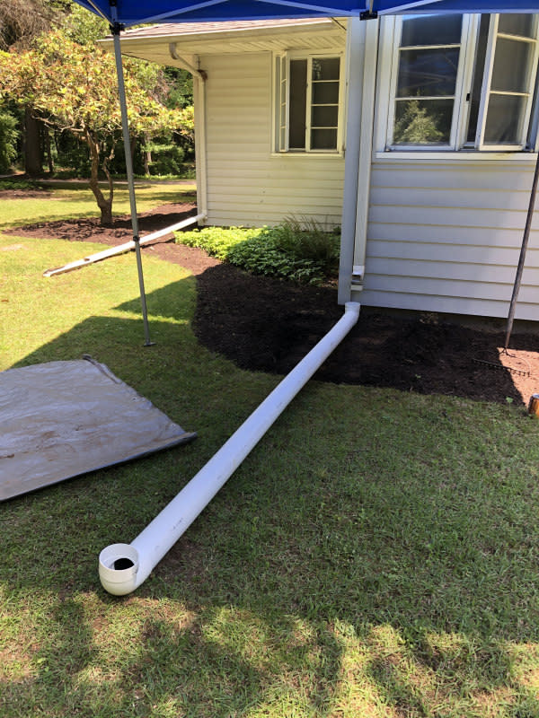 <p>Emily Fazio</p>Step 3. Position the Horizontal Pipe<ul><li>Dry fit the horizontal pieces and elbows together above ground to match your ideal drainage pipe configuration.</li><li>Lay the pieces on the grass, angling away from the house and, if possible, downhill. to make sure everything is the way you want it.</li><li>If there's any question, remember to call 811 before you dig to prevent hitting underground utility lines.</li></ul>