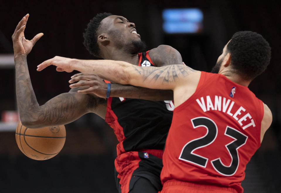 Toronto Raptors guard Fred VanVleet (23) fouls Portland Trail Blazers forward Nassir Little (9) during first-half NBA basketball game action in Toronto, Sunday Jan. 23, 2022. (Frank Gunn/The Canadian Press via AP)