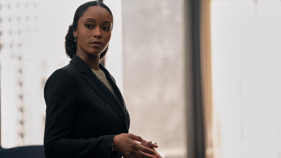 Yaya DaCosta as Andrea standing in front of an office window in The Lincoln Lawyer season 2