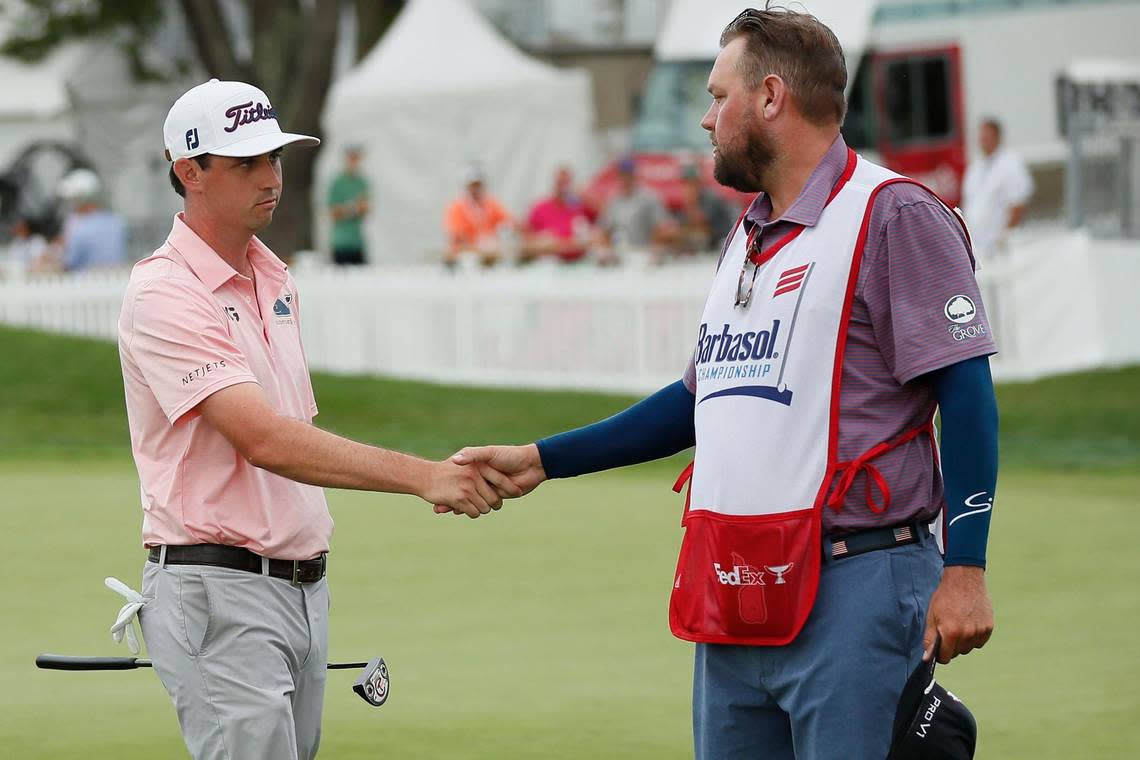 J.T. Poston shakes hands with caddie Aaron Flener during last year’s PGA Barbasol Championship in Nicholasville. Poston was runner-up to champion Seamus Power after a playoff decided last year’s event.