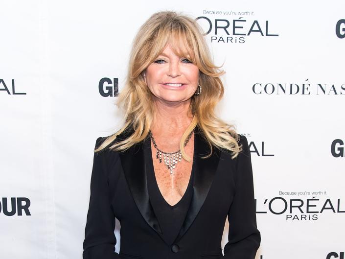 Goldie Hawn smiles on a red carpet.