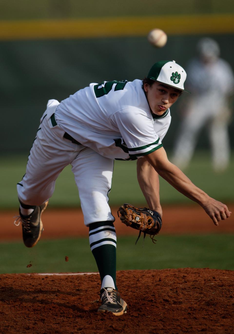 North's Bryce Minton (25) delivers a pitch to a Memorial batter during their game at North High School's Husky Field Thursday evening, April 13, 2023.