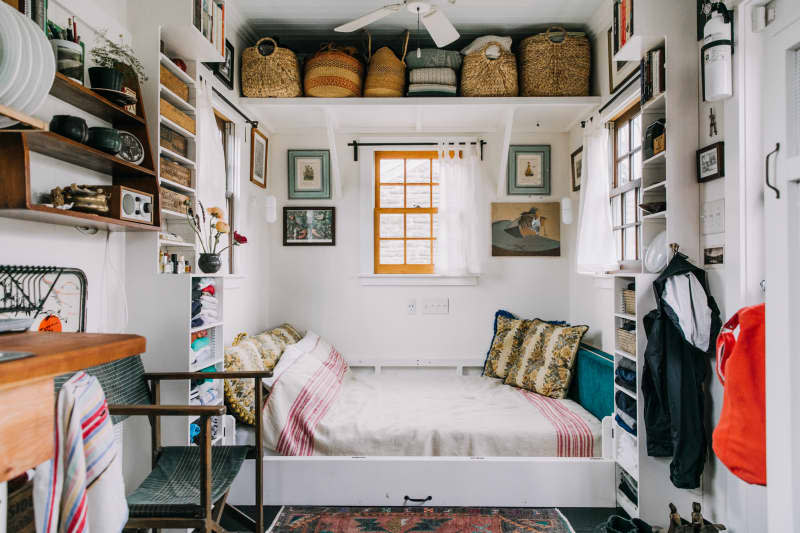 a high, deep shelf above the bed gives plenty of room for large storage baskets