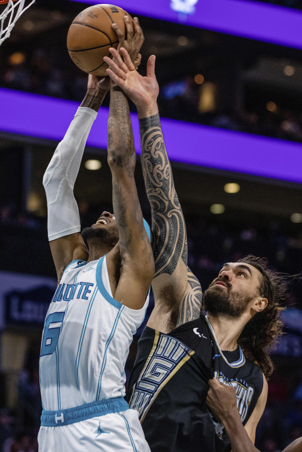 Charlotte Hornets forward Jalen McDaniels (6) grabs the rebound away from Memphis Grizzlies center Steven Adams during the first half of an NBA basketball game on Wednesday, Jan. 4, 2023, in Charlotte, N.C. (AP Photo/Scott Kinser)