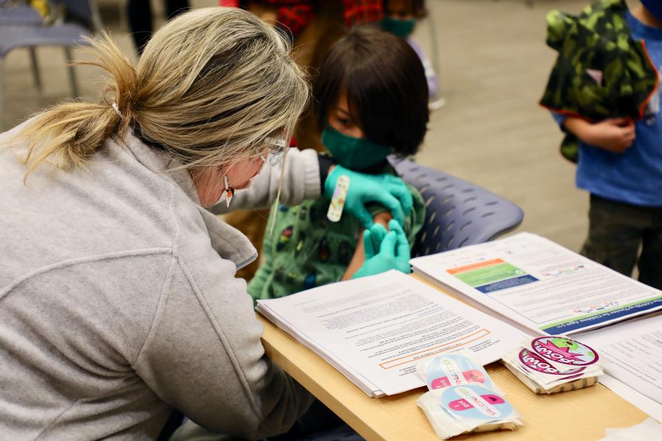 Louis, 7, gets a COVID-19 vaccine at a Cincinnati Children's Hospital Medical Center clinic.